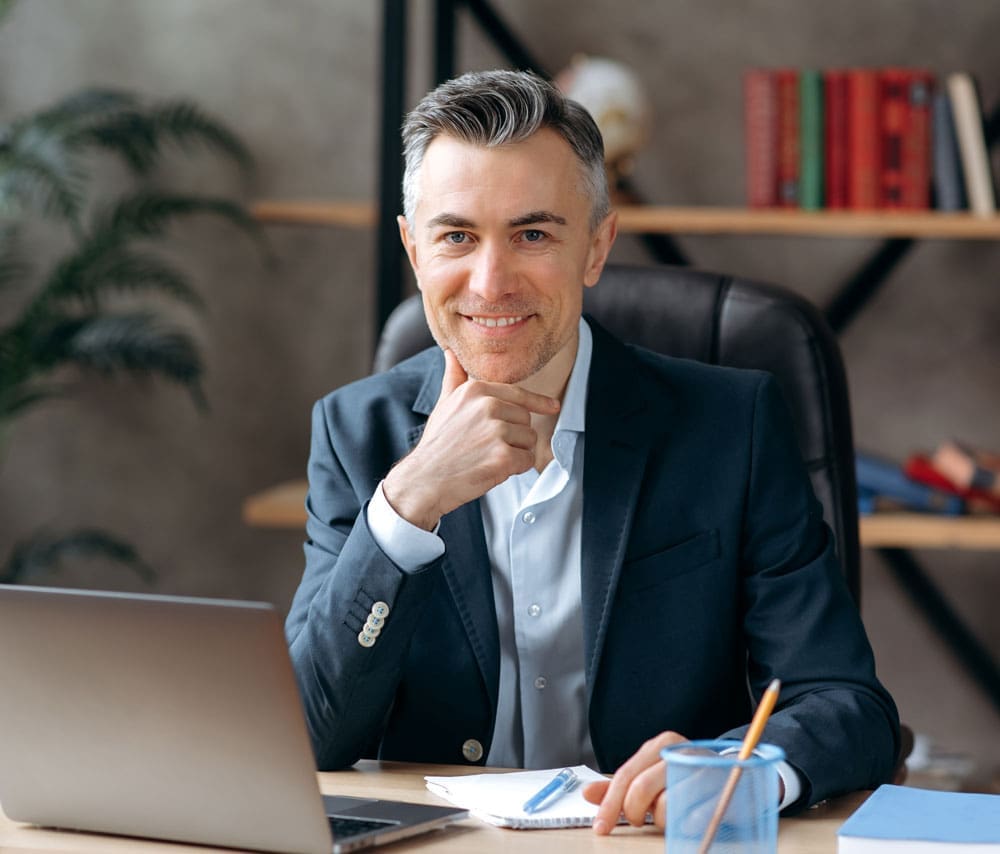 Male Attorney smiling at his desk