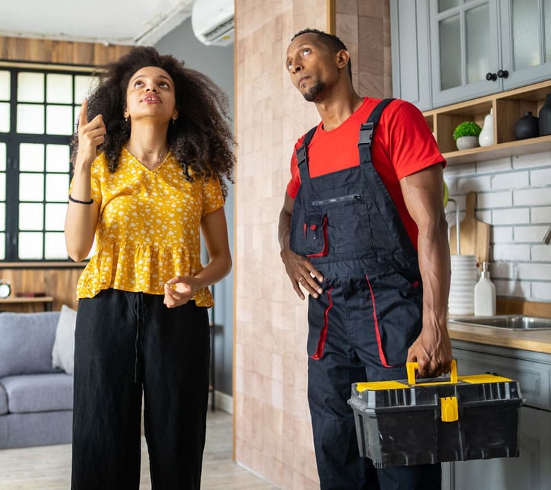 Women showing the damage she needs repaired to a restoration service professional