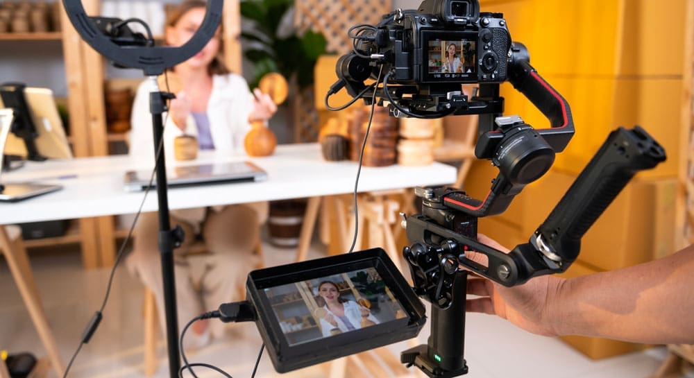 entrepreneur-live-streaming-to-sale-craft-products-to-customers-via-filming-professional-camera- A entrepreneur live streaming to sale craft products to customers via filming professional camera
