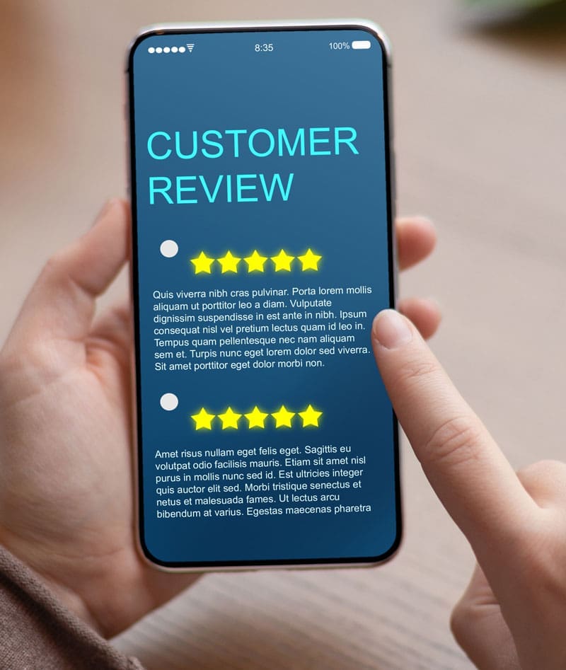 hands holding a phone with customer reviews showing on the screen