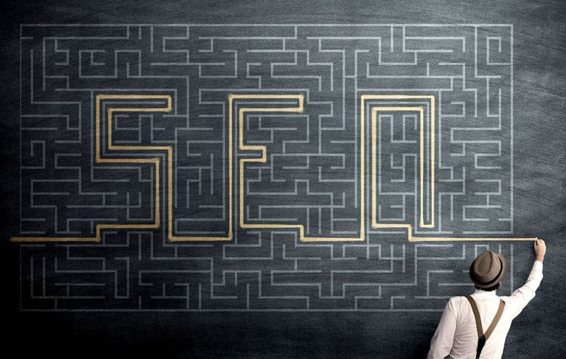 image of a maze on a chalk board and the correct path out spelled SEO